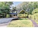 Inviting home exterior with well-maintained lawn, landscaping and mature trees at 975 Timber Lake Trl, Cumming, GA 30041