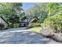Charming craftsman home with stone accents and lush landscaping creating a welcoming curb appeal at 975 Timber Lake Trl, Cumming, GA 30041