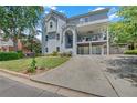 A long driveway leads up to this charming three-story home with its beautifully landscaped yard and welcoming facade at 1420 Cortez Ne Ln, Atlanta, GA 30319