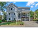 Charming three-story home features a manicured lawn and an open deck, showcasing modern curb appeal at 1420 Cortez Ne Ln, Atlanta, GA 30319