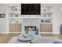 A cozy living room features a stone fireplace, a mounted TV, and built-in shelving at 1420 Cortez Ne Ln, Atlanta, GA 30319