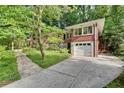 Attractive brick home offering an attached front-facing garage, a driveway and a landscaped yard at 2167 Tanglewood Rd, Decatur, GA 30033