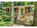 All brick home featuring stone stairs leading up to a green front door with black shutters at 2167 Tanglewood Rd, Decatur, GA 30033