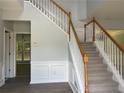 Inviting entryway with a staircase, gray walls, and modern wood-look flooring at 3118 Stanstead Ct, Norcross, GA 30071