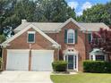 Beautiful brick home with green shutters, a well-kept lawn, and mature trees at 3118 Stanstead Ct, Norcross, GA 30071