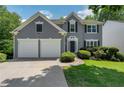 Charming home featuring a manicured lawn, two-car garage, and inviting curb appeal at 1095 Lyndhurst Way, Roswell, GA 30075
