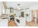 Beautiful kitchen boasts a center island, stainless steel appliances, and modern lighting at 1095 Lyndhurst Way, Roswell, GA 30075