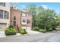 Charming brick townhome with a two-car garage, well-manicured landscaping, and inviting front entrance at 7249 Village Creek Trce, Atlanta, GA 30328