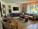 Bright living room with hardwood floors, modern furniture, and a large screen TV at 1038 Ralph Ne Rd, Atlanta, GA 30324