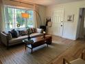 Cozy living room featuring hardwood floors, a large window, and stylish decor at 1038 Ralph Ne Rd, Atlanta, GA 30324