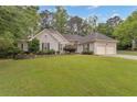 Charming home featuring a well-manicured lawn and a two-car garage, enhancing its curb appeal at 1152 Ward Creek Sw Dr, Marietta, GA 30064