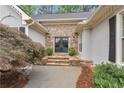 Elegant stone entryway with double doors and manicured landscaping, creating a welcoming entrance at 1152 Ward Creek Sw Dr, Marietta, GA 30064