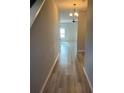 Inviting hallway with wood-look flooring leading to the living areas at 11600 Winston Dr, Hampton, GA 30228