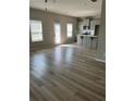 Open-concept living room featuring lots of natural light and modern flooring at 11600 Winston Dr, Hampton, GA 30228