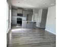 Spacious living area with modern wood floors and an island at 11600 Winston Dr, Hampton, GA 30228