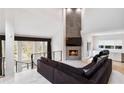 Bright living area featuring a stone fireplace, large windows, and stylish decor at 4 Vale Close Ne Ct, Atlanta, GA 30324