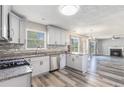Modern kitchen with stainless steel appliances, granite countertops, and hardwood floors at 48 Savanna Ct, Powder Springs, GA 30127