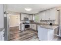 Modern kitchen with stainless steel appliances, granite countertops, and hardwood floors at 48 Savanna Ct, Powder Springs, GA 30127
