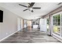 Spacious living room with hardwood floors, bright windows, and open floor plan at 48 Savanna Ct, Powder Springs, GA 30127