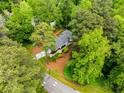 A bird's eye view of a house nestled amongst lush, mature trees in a well-maintained neighborhood at 504 Kingswood Nw Ln, Atlanta, GA 30305