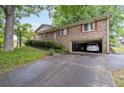 Brick home featuring an attached garage and well-maintained grounds, offering both convenience and classic style at 1690 Cedar Grove Dr, Marietta, GA 30066