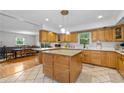 Bright kitchen features an island with granite countertop, custom wood cabinetry, and modern appliances at 1690 Cedar Grove Dr, Marietta, GA 30066