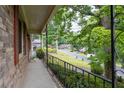 Inviting covered porch with wrought iron railing offering a peaceful view of the neighborhood at 1690 Cedar Grove Dr, Marietta, GA 30066