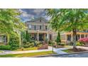 Attractive brick home with a covered front porch, manicured lawn, and mature landscaping at 2043 Mason Mill Rd, Decatur, GA 30033