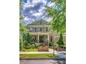 Inviting brick home with a covered porch, detailed landscaping, and well-maintained lawn at 2043 Mason Mill Rd, Decatur, GA 30033
