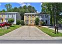 Charming two-story townhouse with a spacious driveway and well-maintained front lawn and landscaped yard at 4120 Buckley Woods Dr, Norcross, GA 30093
