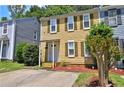 Two-story townhouse with yellow siding, green shutters, and a well-maintained front lawn and landscaped yard at 4120 Buckley Woods Dr, Norcross, GA 30093