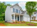 Charming two-story home with a covered front porch and a well-manicured lawn at 174 Bloomfield Cir, Canton, GA 30114