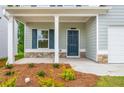 Charming covered front porch with stone accents and craftsman style pillars at 174 Bloomfield Cir, Canton, GA 30114