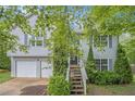 Exterior shot of the home with two-car garage and walkway to the front door at 3694 Arrowhead Pl, Douglasville, GA 30135