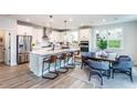 Bright and airy kitchen with white cabinets, stainless steel appliances, and an island with bar seating at 5121 Hillside Haven Drive, Powder Springs, GA 30127