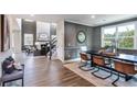 Open-concept living space with a dining area, living room with fireplace, and hardwood floors at 5121 Hillside Haven Drive, Powder Springs, GA 30127