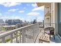 Balcony featuring a chair, table, and a stunning view of the city skyline at 860 Peachtree Ne St # 1712, Atlanta, GA 30308
