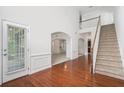 Elegant foyer with hardwood floors, staircase, and high ceilings creates a grand entrance at 7280 Wright Dr, Atlanta, GA 30349