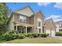 Beautiful two-story brick home with a welcoming front porch and well-maintained landscaping at 7280 Wright Dr, Atlanta, GA 30349