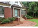 Inviting front entrance with classic brick steps, blue door, columns, and meticulously maintained shrubbery at 96 Dartmouth Ave, Avondale Estates, GA 30002