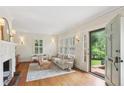 Bright living room with hardwood floors, fireplace, plantation shutters and a modern design at 96 Dartmouth Ave, Avondale Estates, GA 30002