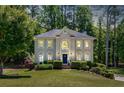 Charming two-story home with a well-manicured lawn, complemented by mature trees for added privacy at 222 Mossy Pl, Alpharetta, GA 30005