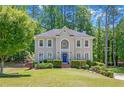 Charming two-story home with a well-manicured lawn, complemented by mature trees for added privacy at 222 Mossy Pl, Alpharetta, GA 30005