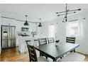 Bright kitchen and dining area with stainless steel appliances, pendant lighting and modern table and chairs at 2276 Sutton Se St, Atlanta, GA 30317