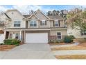 Inviting townhome showcasing a two-car garage, tidy landscaping, and a welcoming facade at 331 Franklin Ln, Acworth, GA 30102