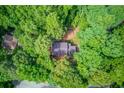 Aerial view of a home nestled among lush green trees offering privacy and seclusion at 3741 Windhurst Dr, Lilburn, GA 30047