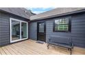 Relaxing deck area featuring a sliding glass door and comfortable seating at 4131 West Village Pkwy, Ellenwood, GA 30294