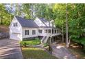 Charming two-story home with a porch, an attached garage, and a manicured yard at 7240 Highbrook Cir, Cumming, GA 30041