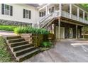 Charming two-story home with a porch, stairs, and a stone foundation at 7240 Highbrook Cir, Cumming, GA 30041