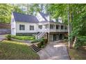 Charming two-story home with a porch, an attached garage, and a stone foundation at 7240 Highbrook Cir, Cumming, GA 30041
